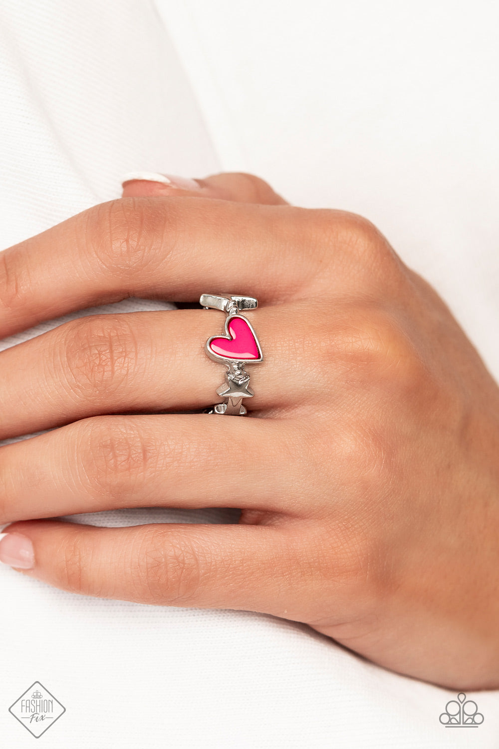 Contemporary Charm - Pink Heart - Silver Fashion Ring - Paparazzi Accessories - A small pink heart is wrapped in a thick silver frame and nestled between a tiny lightning bolt and star on a skinny silver band that arcs across the finger. Features a dainty stretchy band for a flexible fit. Sold as one individual ring. Bejeweled Accessories By Kristie - Trendy fashion jewelry for everyone -