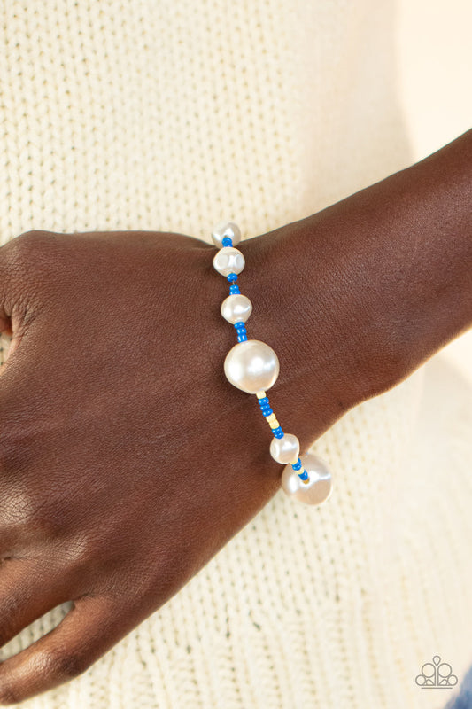 Contemporary Coastline - Blue Bracelet - Paparazzi Accessories - Irregular-shaped pearls in varying sizes are scattered amongst blue and yellow seed beads that are threaded along a wire, resulting in a refreshing and playful style around the wrist. Features an adjustable clasp closure. Sold as one individual bracelet.