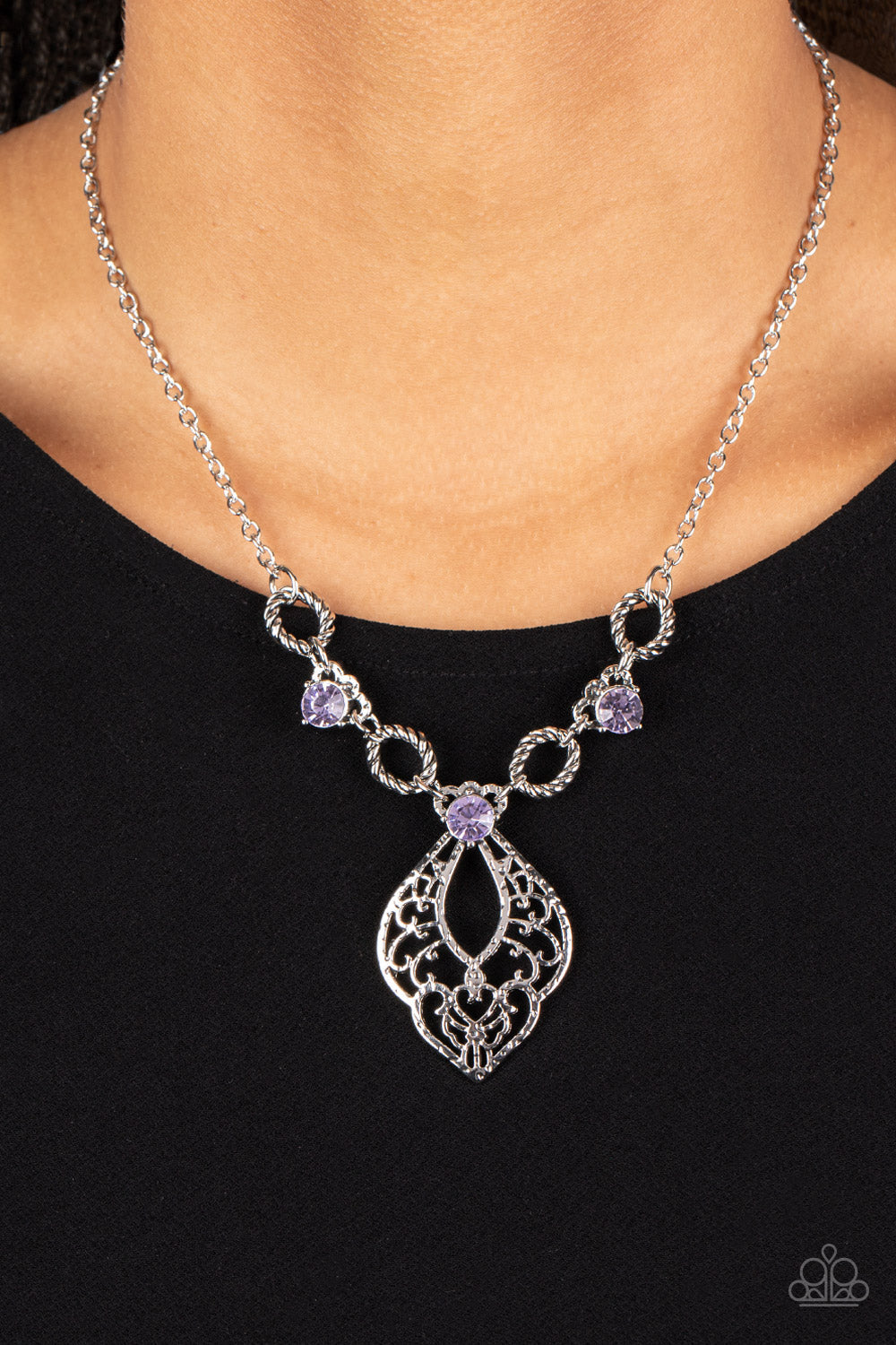 Contemporary Connections - Purple and Silver Necklace - Twisted silver links and oversized purple rhinestones delicately alternate below the collar. A hammered filigree filled silver pendant shimmers from the bottom of the centermost rhinestone, creating a contemporary pendant. Features an adjustable clasp closure. Sold as one individual necklace.