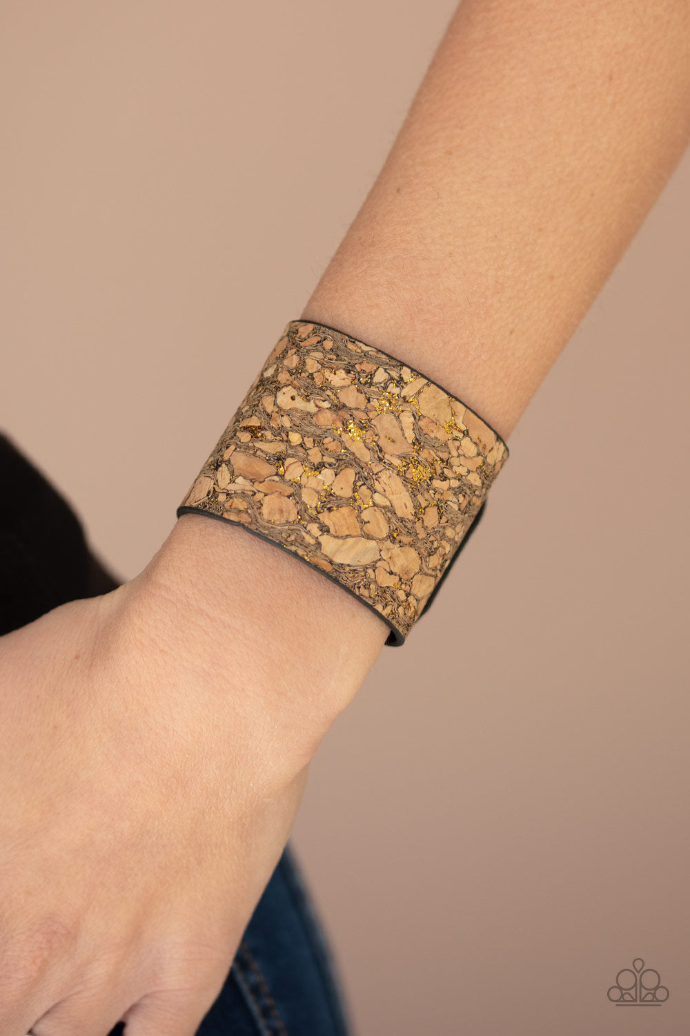 Cork Congo - Brass Snap Closure Bracelet - Paparazzi Accessories - Pieces of cork have been plastered across the front of a black leather band, creating an earthy look around the wrist. Specks of glittery brass accents are sprinkled across the front for a flashy finish. Adjustable snap closure fashion bracelet.