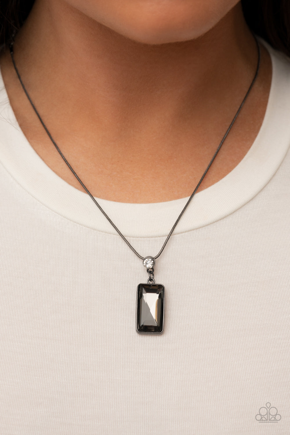 Cosmic Curator - Smoky Gem Gunmetal Necklace - Paparazzi Accessories - Encased in a sleek gunmetal frame, an emerald cut smoky gem swings from the bottom of a solitaire white rhinestone along a rounded gunmetal snake chain for an out-of-this-world stylish necklace. Bejeweled Accessories By Kristie - Trendy fashion jewelry for everyone -