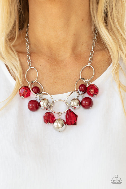 Cosmic Getaway - Red and Silver Necklace - Paparazzi Accessories - Infused with faceted Samba crystal-like beads, a bubbly collection of oversized silver and Samba beads swing from the bottom of an interconnected row of bold silver oval frames, creating a colorful fringe below the collar.