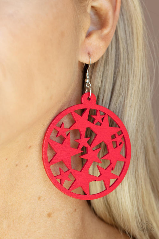 Cosmic Paradise - Red Wood Star Earrings - Paparazzi Accessories - An oversized round red wooden frame is filled with a cosmos of cut-out red stars creating a whimsical statement. Earring attaches to a standard fishhook fitting.
