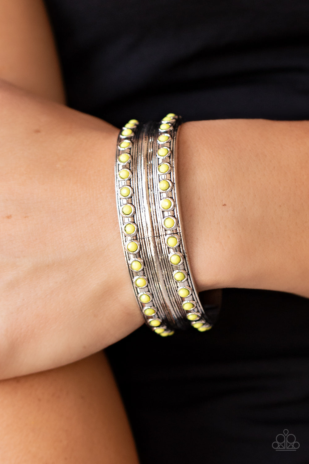 Costa Rica Retreat - Yellow and Silver Cuff Bracelet - Paparazzi Accessories - Etched and embossed in stacks of linear texture, an antiqued silver cuff is bordered in rows of faceted Illuminating beads for a vivacious finish. Sold as one individual bracelet.