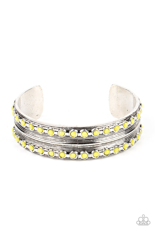 Costa Rica Retreat - Yellow and Silver Cuff Bracelet - Paparazzi Accessories - Etched and embossed in stacks of linear texture, an antiqued silver cuff is bordered in rows of faceted Illuminating beads for a vivacious finish. Sold as one individual bracelet.
