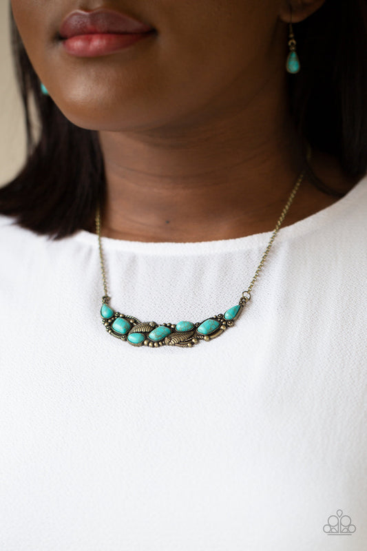 Cottage Garden - Brass and Turquoise Necklace - Paparazzi Accessories - A collection of asymmetrical turquoise stones adorns the front of a studded brass frame embossed in floral and feathery accents below the collar, creating a seasonal centerpiece.