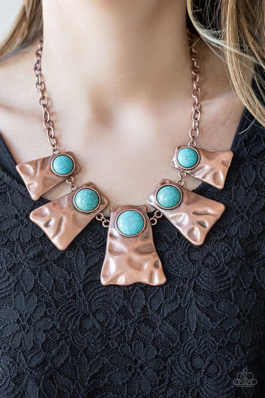 Cougar - Blue Turquoise - Copper Necklace - Paparazzi Accessories - Rippling with hammered details, flared copper frames join below the collar, creating a fierce fringe. Refreshing turquoise stones are pressed into the tops of the frames for a colorful finish. Features an adjustable clasp closure.