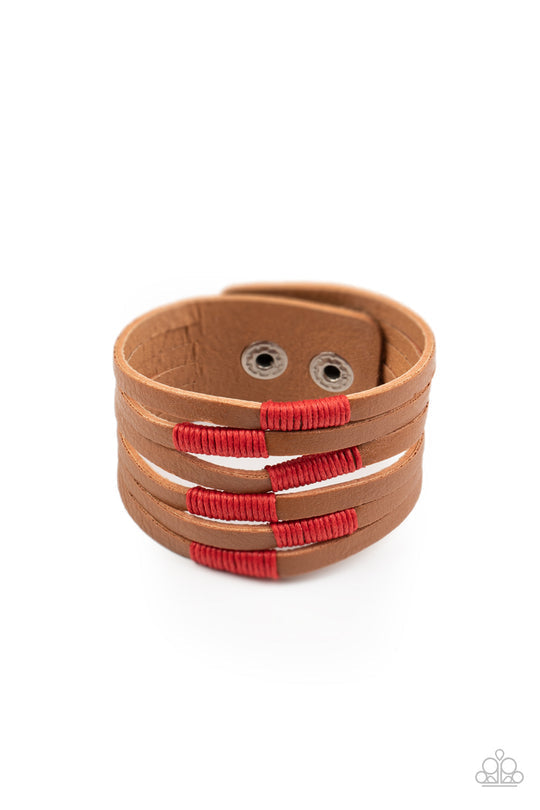 Country Colors - Red and Brown Leather Snap Bracelet - Paparazzi Accessories - A brown leather band has been spliced into layered rows that wrap around the wrist. Red threaded accents wrap around the leather strips, creating a colorfully rustic display. Features an adjustable snap closure. Sold as one individual bracelet.
