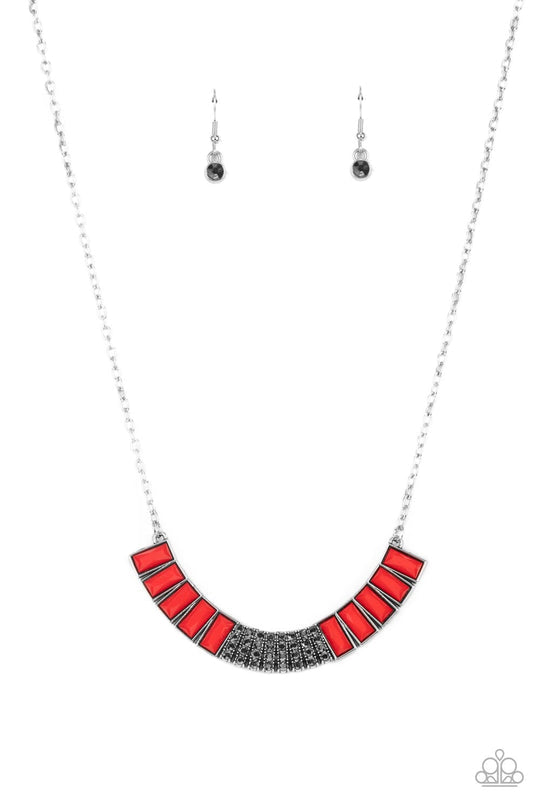 Coup de MANE - Red and Silver Fashion Necklace - Paparazzi Accessories - Stacked rows of hematite rhinestones and faceted emerald cut Fire Whirl beads coalesce into a colorful half moon pendant, creating a flamboyant pop of color below the collar. Features an adjustable clasp closure.