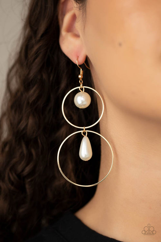 ​Cultured in Couture - White Pearl and Gold Fashion Earrings - Paparazzi Accessories - A classic white pearl swings from the top of a shiny gold hoop that is linked to another gold hoop by a pearly teardrop bead, creating a stunningly stacked display. Earring attaches to a standard fishhook fitting. Sold as one pair of earrings.