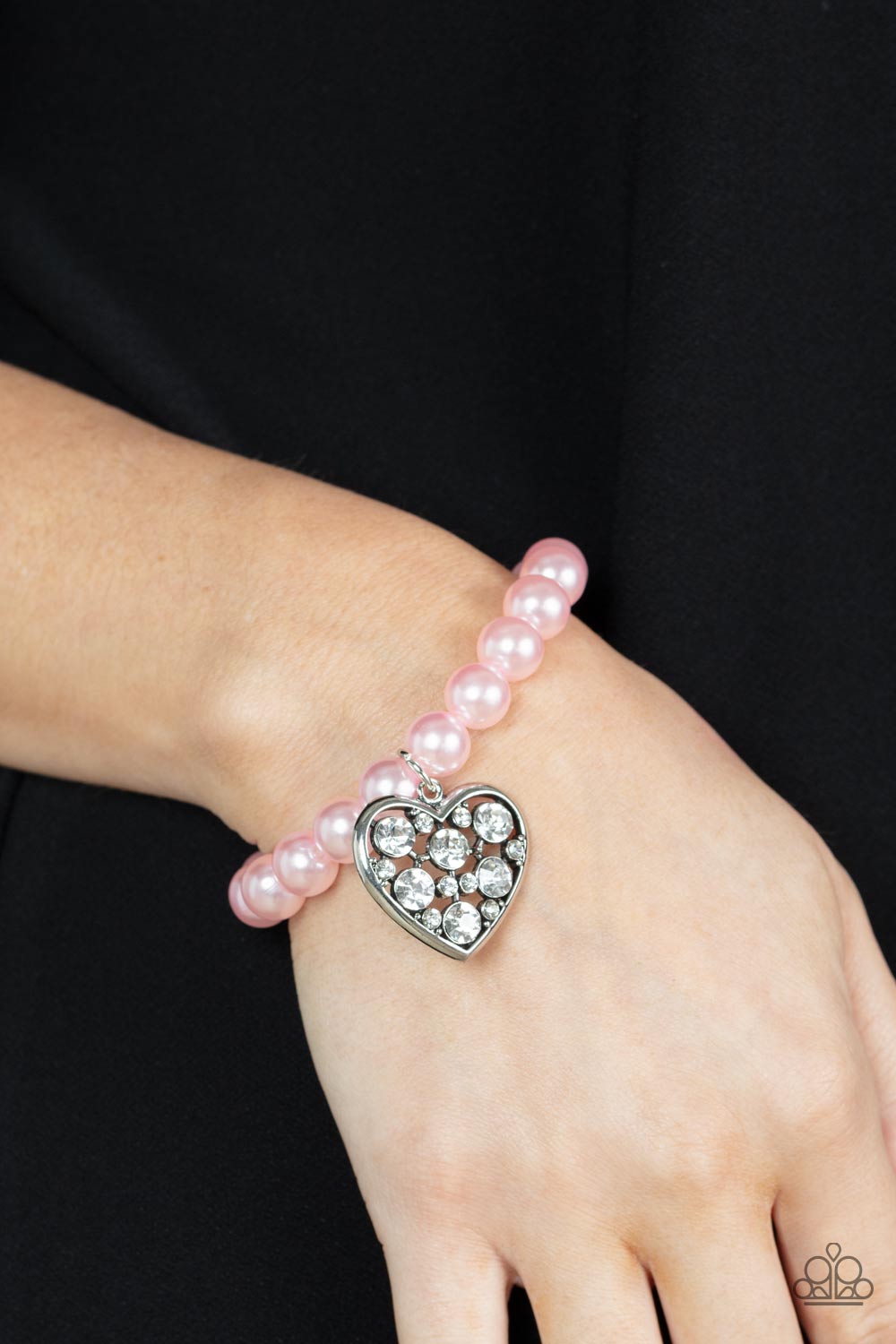 Cutely Crushing Pink Pearl - Heart Charm - Stretchy Bracelet - Paparazzi Accessories - A dramatically oversized white rhinestone encrusted silver heart charm dangles from a stretchy strand of bubbly pink pearls, creating a dazzle around your wrist.