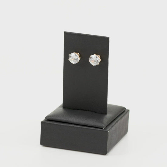 Just In TIMELESS - Gold Earrings - Paparazzi Accessories 
A sparkling white rhinestone is nestled inside a classic gold frame for a timeless look. Earring attaches to a standard post fitting. Sold as one pair of post earrings.
