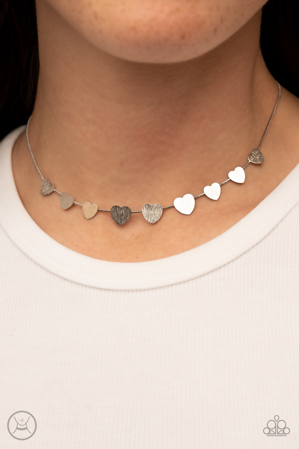 Dainty Desire - Silver Heart Choker Necklace - Paparazzi Accessories - a dainty collection of flat silver heart frames gradually increases in size along a shiny silver snake chain around the neck for a flirtatious fashion. Features an adjustable clasp closure. Bejeweled Accessories By Kristie - Trendy fashion jewelry for everyone -
