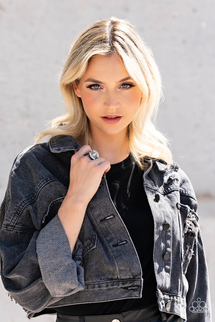 Daringly Deco - Black Ring - Paparazzi Accessories - A white, marquise-cut rhinestone is bordered in glassy white rhinestones atop fans of trapezoidal-cut white rhinestones, resulting in an edgy sparkle that explodes atop the finger. Features a stretchy band for a flexible fit.