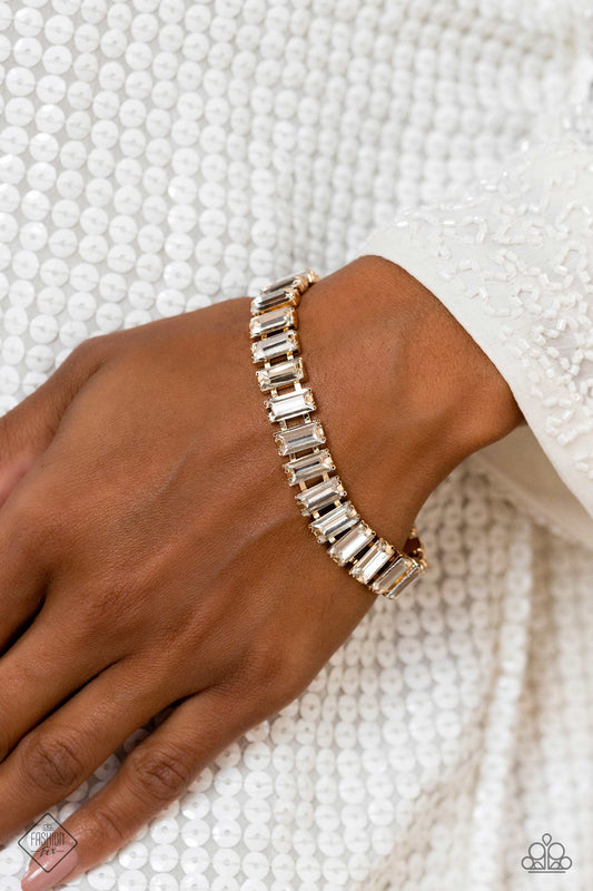 Darling Debutante - Gold Bracelet - Paparazzi Accessories - Set in prominent, pronged gold fittings, a glassy collection of emerald-cut, white gems fall in line around the wrist, creating a stunning, light-catching display. Features an adjustable clasp closure. Sold as one individual bracelet.