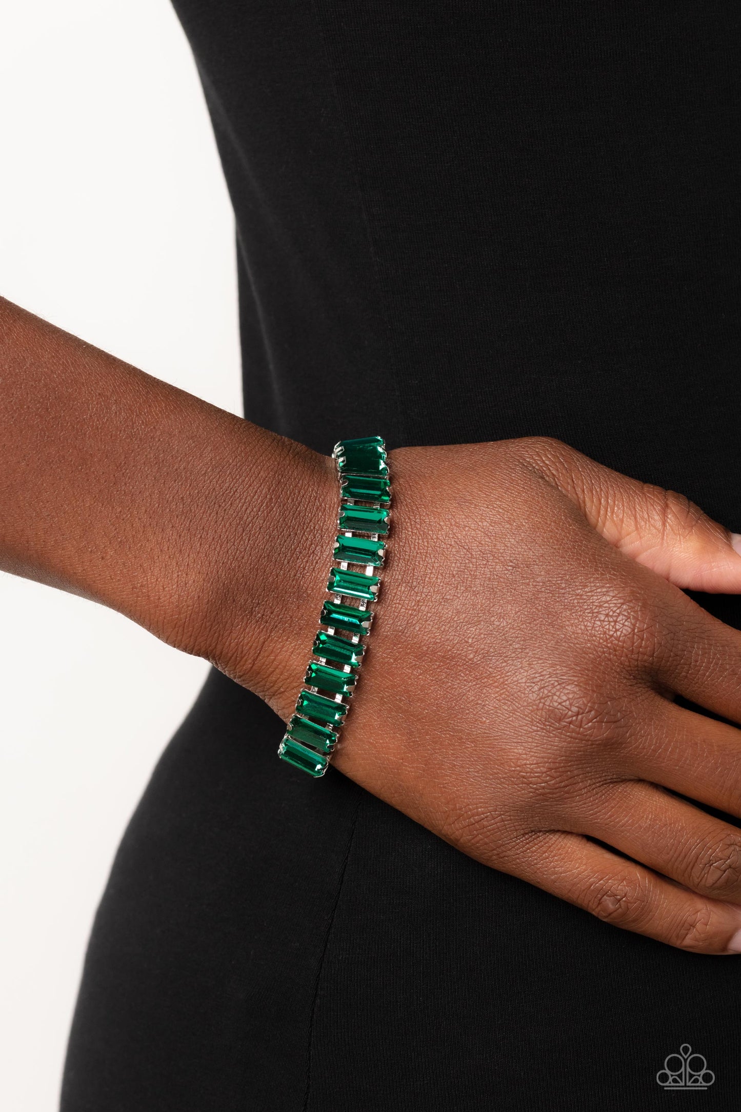 Darling Debutante - Green Gem Bracelet - Paparazzi Accessories - Set in prominent, pronged silver fittings, a glassy collection of emerald-cut, green gems fall in line around the wrist, creating a stunning, light-catching display. Features an adjustable clasp closure. Sold as one individual bracelet.
