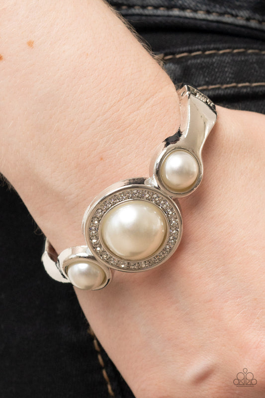 Debutante Daydream - White Pearl - Silver Hinge Closure Bracelet - Paparazzi Accessories - Glitzy glassy white rhinestones, an oversized white pearl is flanked by a pair of bubbly white pearl fittings atop a classic silver bangle-like bracelet for a timeless twist. Features a hinged closure.
