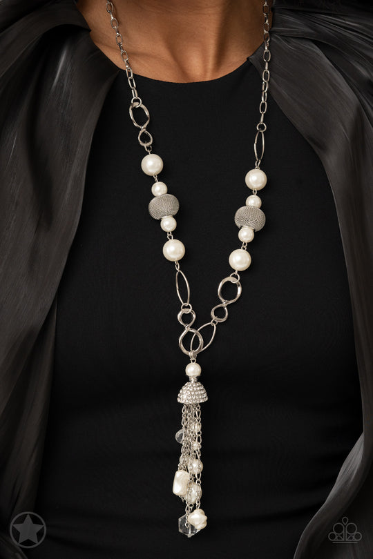 Designated Diva - White Pearl and Silver Necklace - Paparazzi Accessories - A half-shell studded in rhinestones overhangs a cluster of ivory pearls, tassels of silver chain, and small crystals. Two large wire mesh spheres and larger ivory pearls decorate the neckline. Sold as one individual necklace.