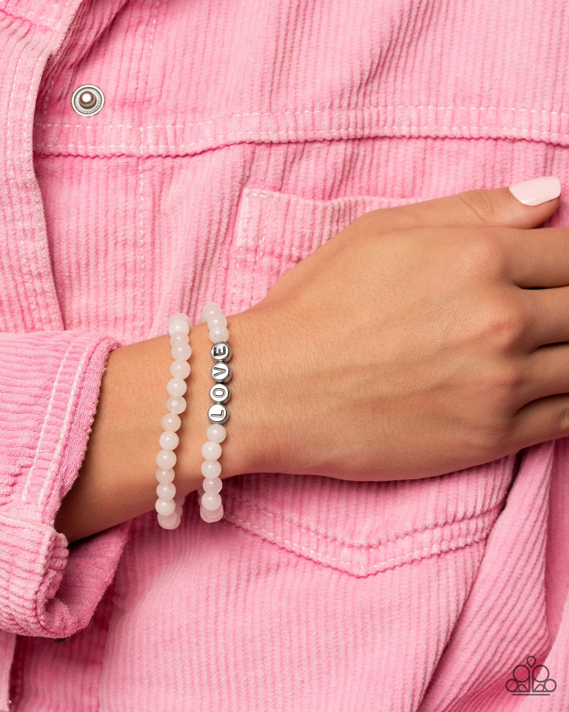 Devoted Dreamer - White and Silver Bracelet - Paparazzi Accessories - Cloudy beads in subtle shades of white extend around the wrist on elastic stretchy bands for a two-for-one romantic stack. Centered on one of the white bracelets, silver discs stamped with individual black letters spell out the word "love." Sold as one individual bracelet.