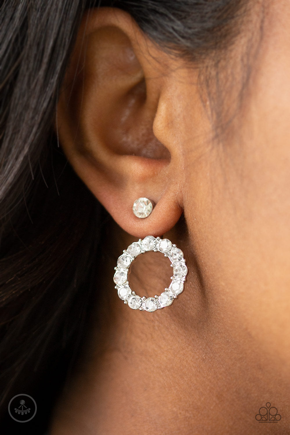 Diamond Halo - White and Silver Rhinestone Earrings - Paparazzi Accessories - 
A solitaire white rhinestone attaches to a double-sided post, designed to fasten behind the ear. Encrusted in a ring of glassy white rhinestones, the glittery hoop peeks out beneath the ear for a glamorous look. Earring attaches to a standard post fitting.
Sold as one pair of double-sided post earrings.