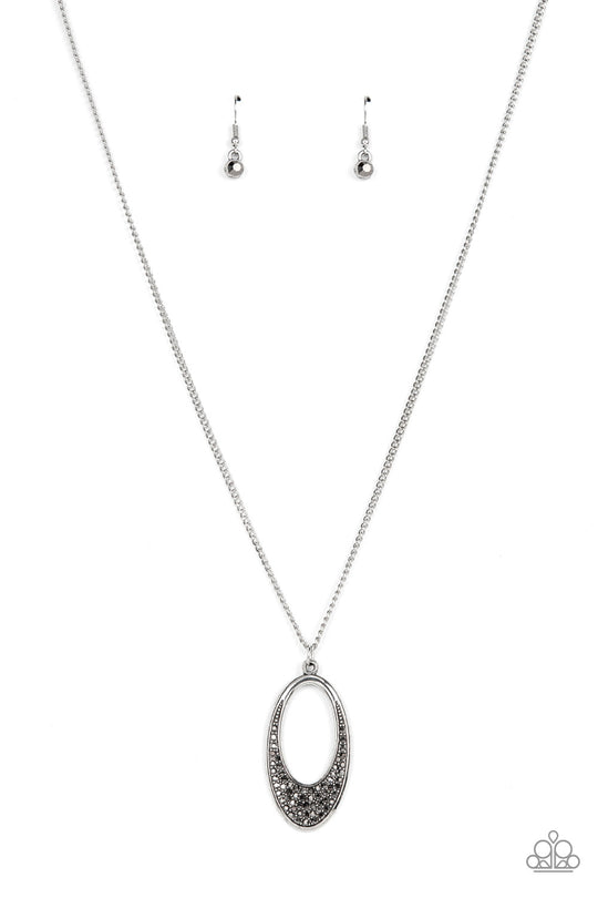 Dip It Into Dazzle - Silver Necklace - Paparazzi Accessories - Encrusted with smoky hematite rhinestones, a simple oval frame featuring an airy oval cutout creates a stylishly modern pendant at the end of a lengthened silver chain. Features an adjustable clasp closure. Sold as one individual necklace.