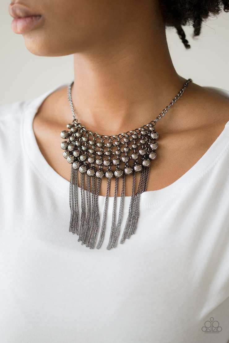 DIVA-de and Rule - Black Metal Necklace - Paparazzi Accessories - Gradually increasing in size, glistening gunmetal beads swing from a net of interlocking gunmetal links. Shimmery gunmetal chains stream from the bottom of the beaded fringe for an edgy finish. Features an adjustable clasp closure.