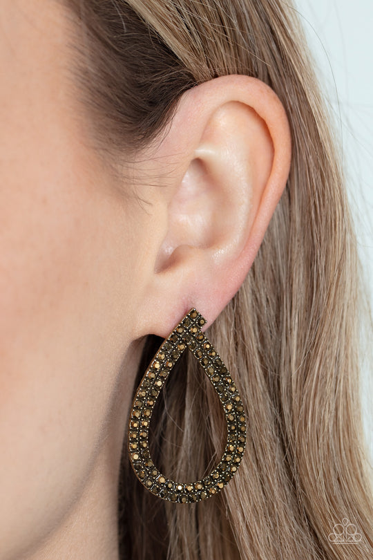 Diva Dust - Brass Fashion Earrings - Paparazzi Accessories - Glitzy ribbons of dainty aurum rhinestones delicately swoop into a gritty teardrop frame, resulting in a sultry sparkle. Earring attaches to a standard post fitting.