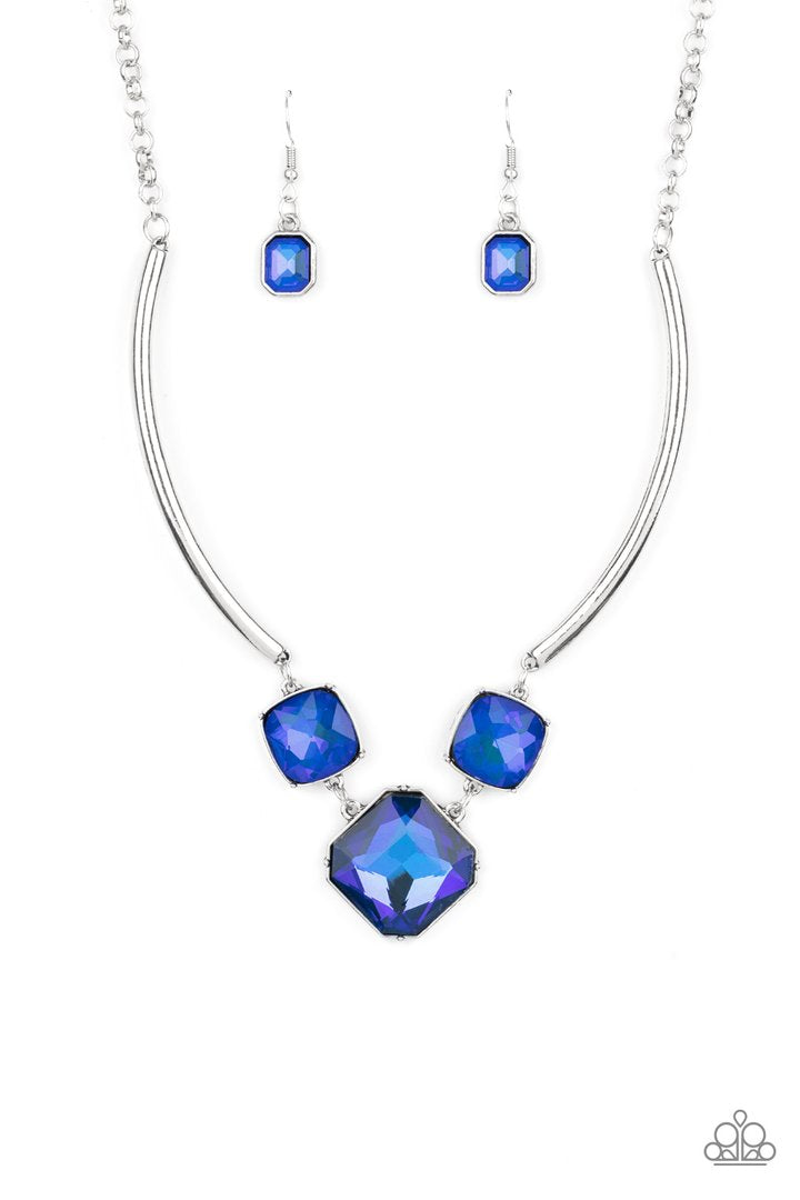 Divine IRIDESCENCE - Blue - Silver Necklace and Earrings - Paparazzi Accessories - 
Featuring a subtle UV shimmer, an oversized collection of radiant cut blue gems delicately link at the bottom of two curved silver rods. Attached to shiny silver chains, the glamorously glitzy display sparkles below the collar for a jaw-dropping finish. Features an adjustable clasp closure.
Sold as one individual necklace. Includes one pair of matching earrings.
