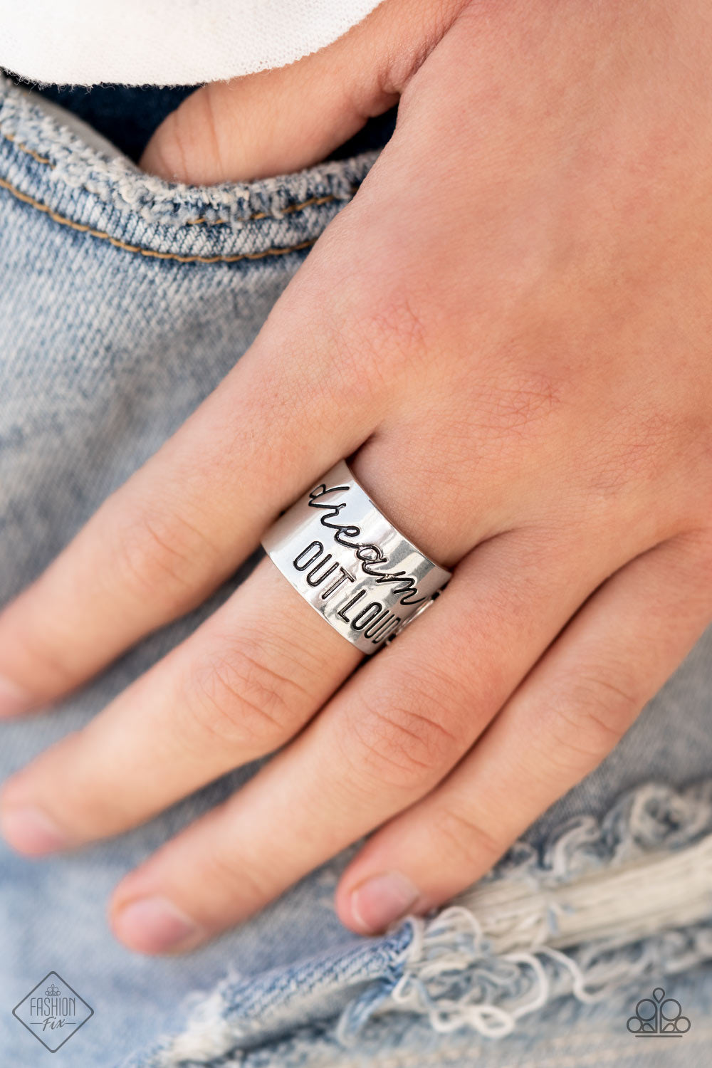 ​Dream Louder - Dream Out Loud - Silver Ring - Paparazzi Accessories - 
The front of a thick silver band is stamped in the phrase, "Dream out loud," creating an inspirational centerpiece across the finger. Features a stretchy band for a flexible fit.
Sold as one individual ring.
