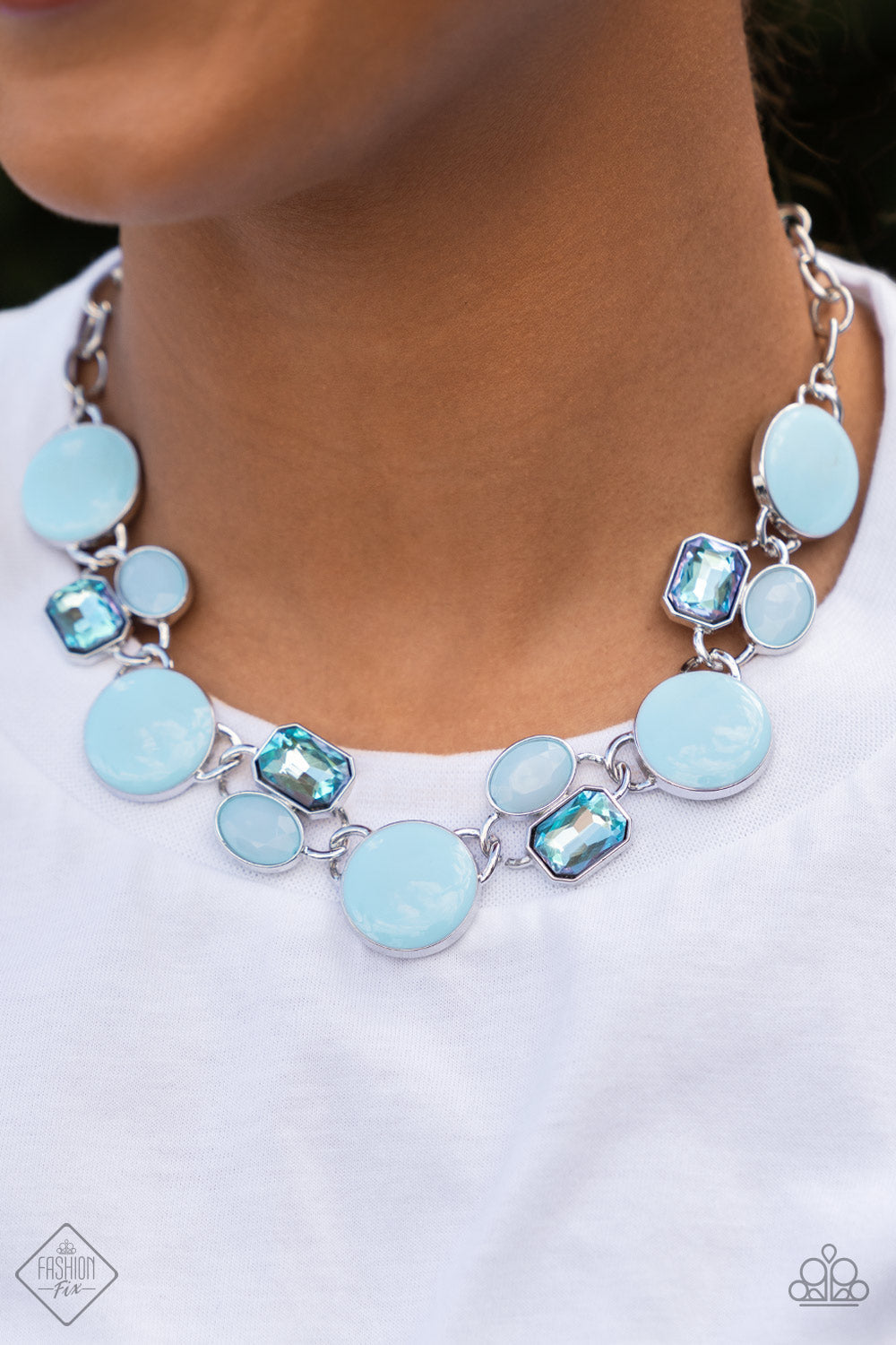 Dreaming in MULTICOLOR - Blue Gem - Silver Necklace - Paparazzi Accessories - Sweet pastel of Spun Sugar, sparkling blue gems combine with milky blue beads and alternate across the collar with oversized discs painted in blue enamel. The whimsically modern collection connects to a silver chain resulting in a charismatic display below the collar.