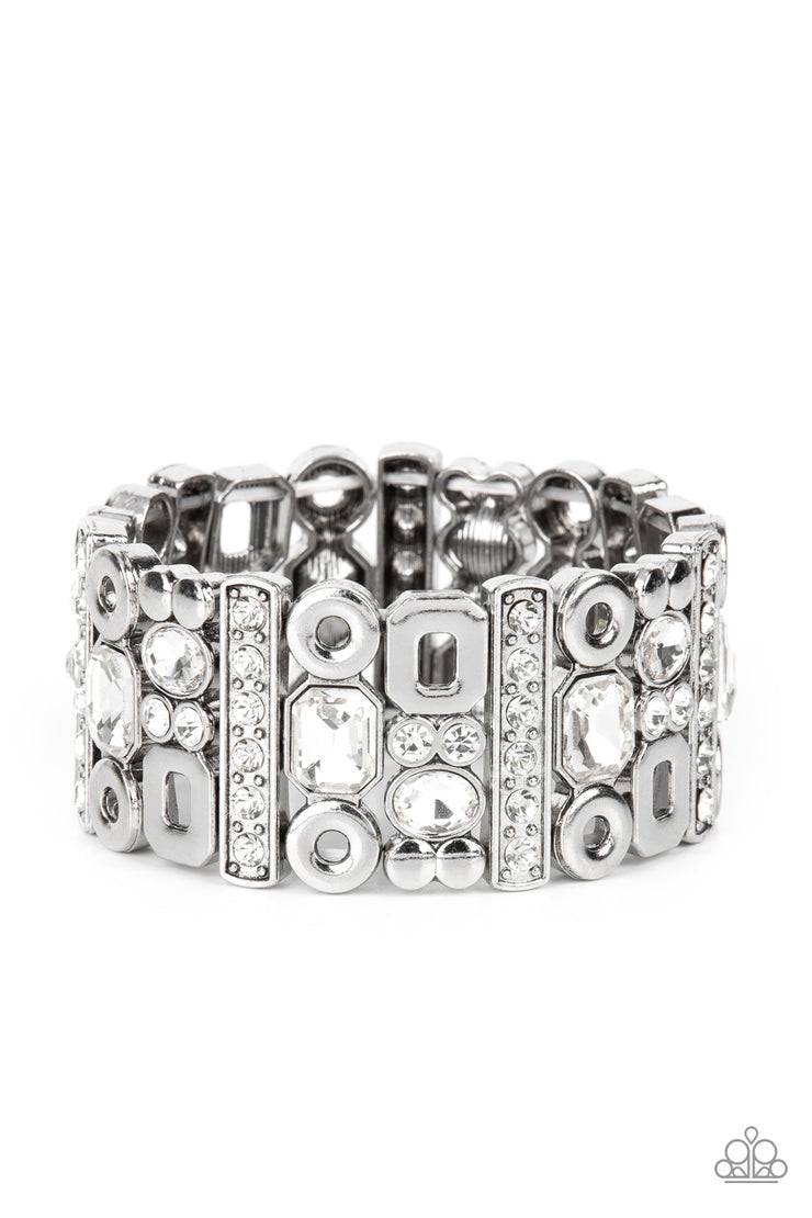 Dynamically Diverse - White and Silver Stretchy Bracelet - Paparazzi Accessories - Geometric silver accents, a mismatched assortment of oval, round, and emerald style white rhinestones coalesce into edgy frames along a stretchy band for an intense sparkle around the wrist.