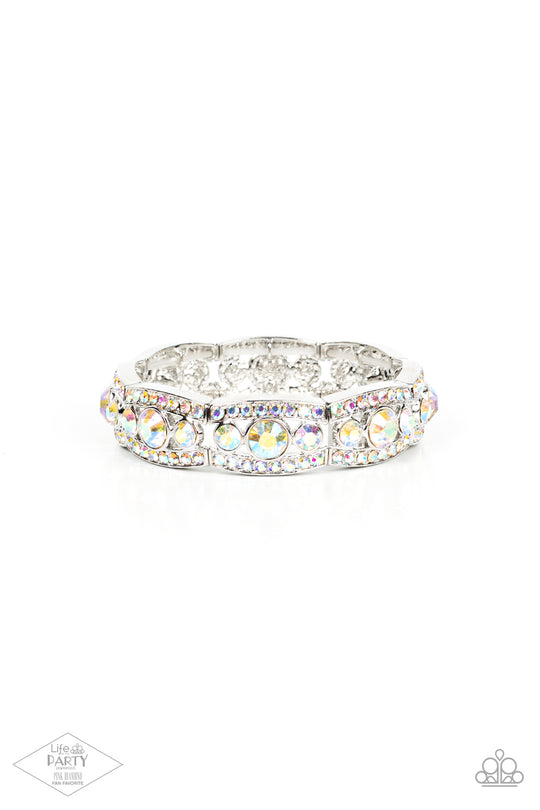 Easy On The Ice - Multi Iridescent Bracelet - Paparazzi Accessories - Iridescent rhinestone encrusted silver bars flank a dazzling trio of oversized iridescent rhinestones, coalescing into a glittery frame. The sparkly frames are threaded along stretchy bands around the wrist, creating an irresistible shimmer. Sold as one individual bracelet.