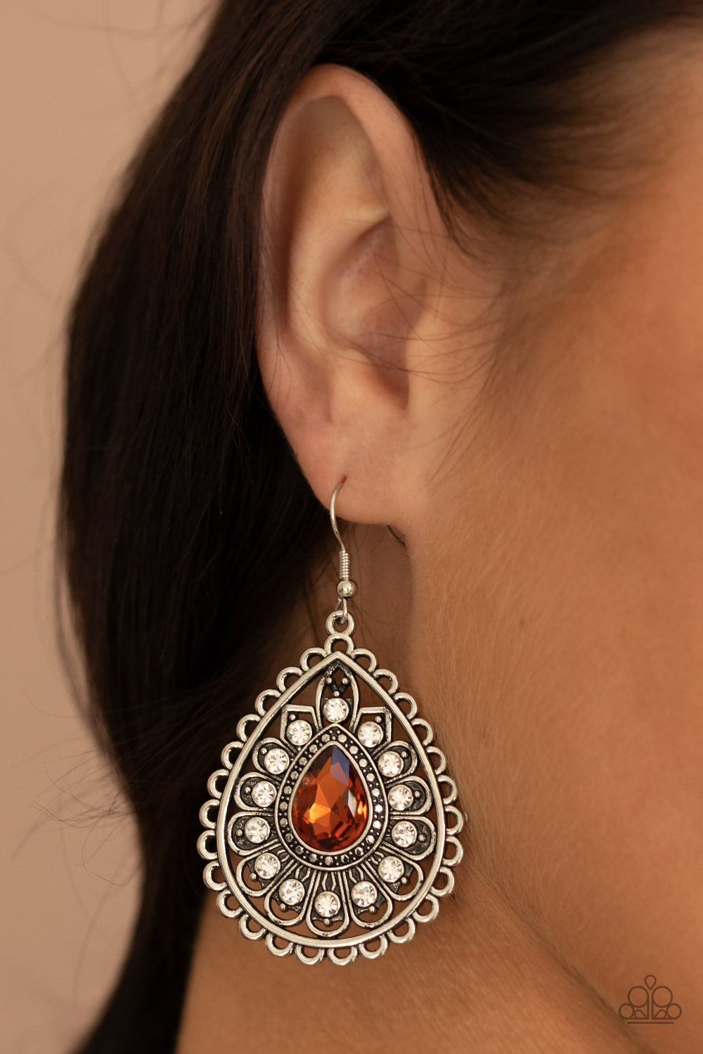 Eat, Drink, and BEAM Merry - Brown Topaz and Silver Earrings - Paparazzi Accessories - White rhinestone dotted silver petals flare out from a topaz teardrop rhinestone center, coalescing into a frilly frame. Earring attaches to a standard fishhook fitting. Sold as one pair of earrings.