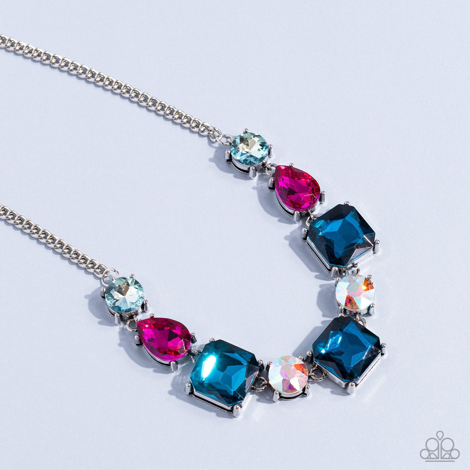 Elevated Edge - Multi Color and Silver Necklace - Paparazzi Accessories - A geometric collection of pink fuchsia, light blue, dark blue, and iridescent rhinestones, featured in square, teardrop, and round shapes coalesces down the neckline for a gritty, yet glamorous display necklace.