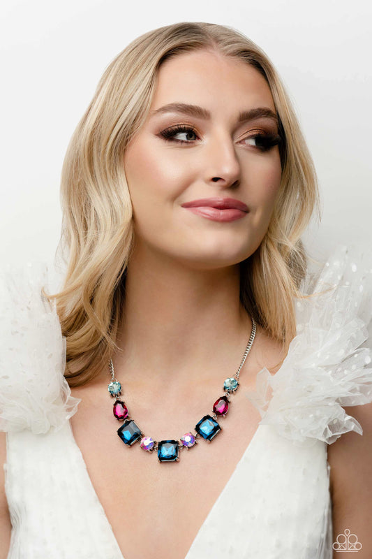 Elevated Edge - Multi Color and Silver Necklace - Paparazzi Accessories - A geometric collection of pink fuchsia, light blue, dark blue, and iridescent rhinestones, featured in square, teardrop, and round shapes coalesces down the neckline for a gritty, yet glamorous display necklace.