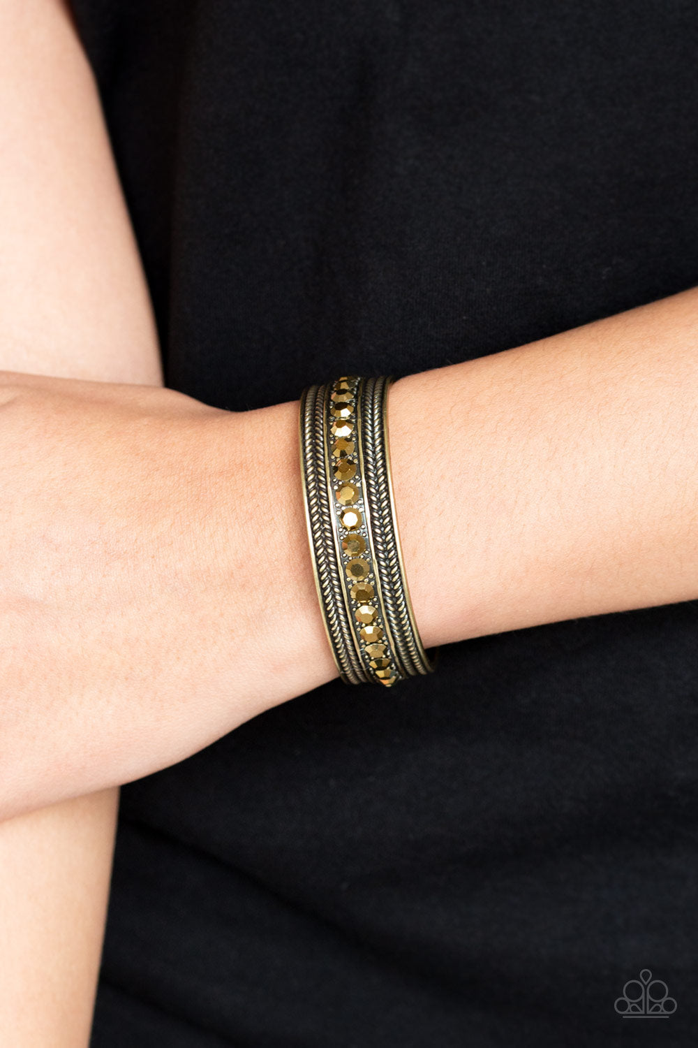 Empress Etiquette - Brass Cuff Bracelet - Paparazzi Accessories - A row of glittery aurum rhinestones are encrusted down the center of a studded brass cuff for an edgy look. Sold as one individual bracelet.