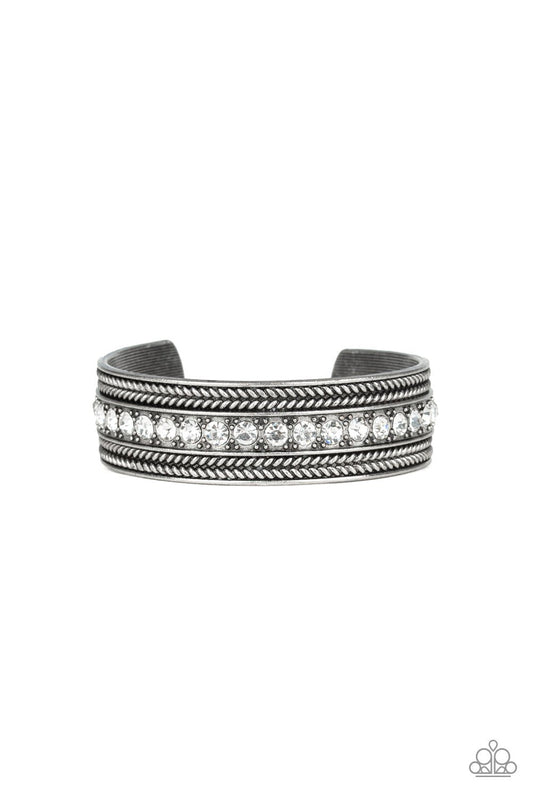 Empress Etiquette - White and Silver Cuff Bracelet - Paparazzi Accessories - A row of glittery white rhinestones line the center of a studded silver cuff for an edgy look. Sold as one individual bracelet.