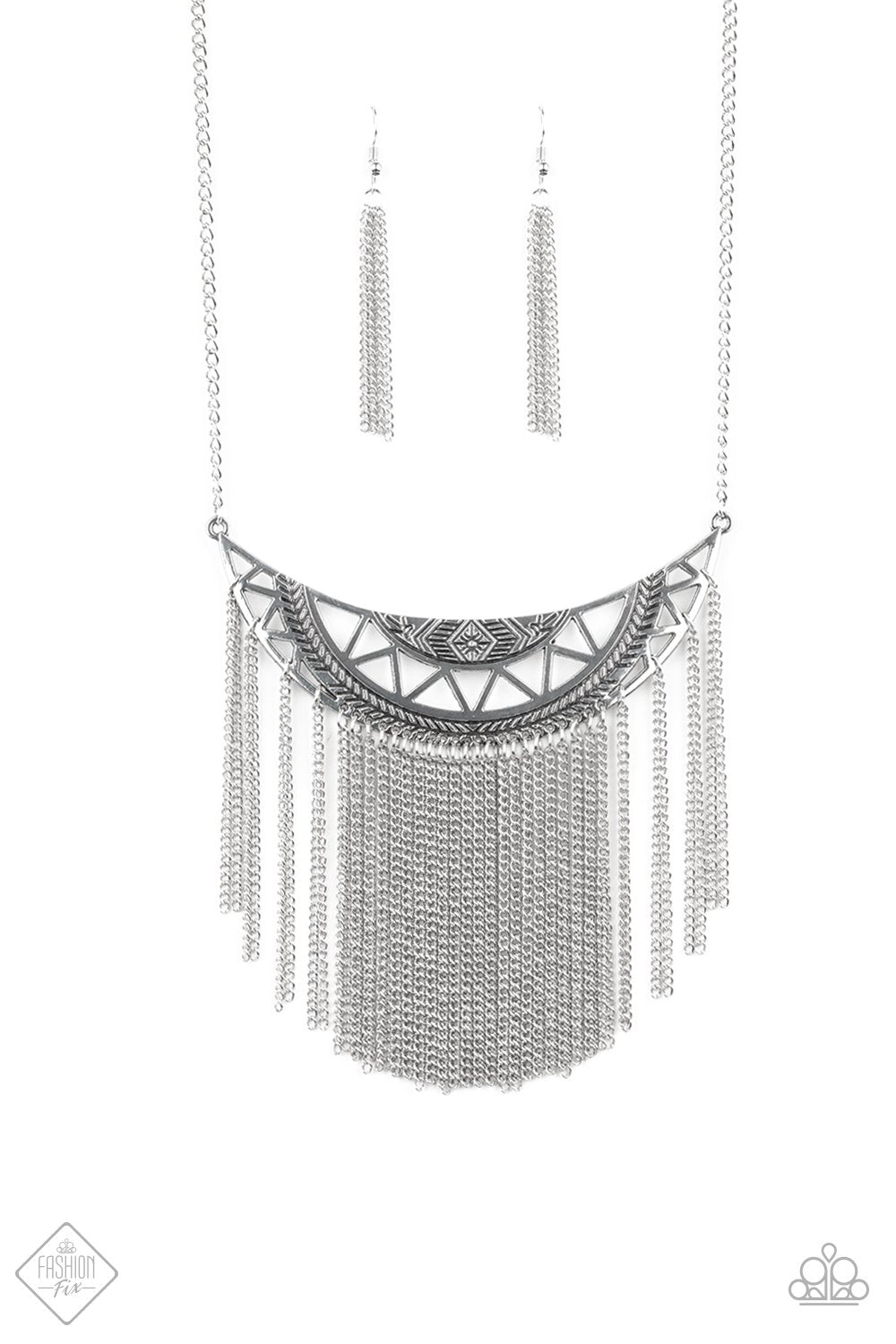 Empress Excursion Necklace - Paparazzi Jewelry - Bejeweled Accessories By Kristie - A stenciled silver crescent stamped in tribal inspired patterns swings unapologetically below the collar. A curtain of shimmery silver chains cascades from the bottom of the dramatic pendant, creating a bold fringe with endless movement. Features an adjustable clasp closure. Sold as one individual necklace.