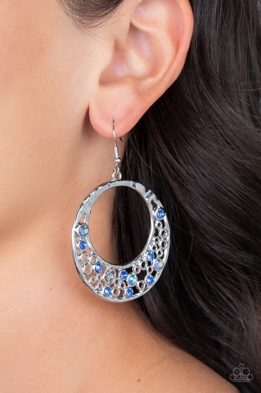 Enchanted Effervescence - Blue Iridescent and Silver Earrings - Paparazzi Accessories - A glittery collection of blue and iridescent rhinestones joins with dainty silver circles along the bottom of a hammered silver frame, bubbling into an extravagant effervescence.