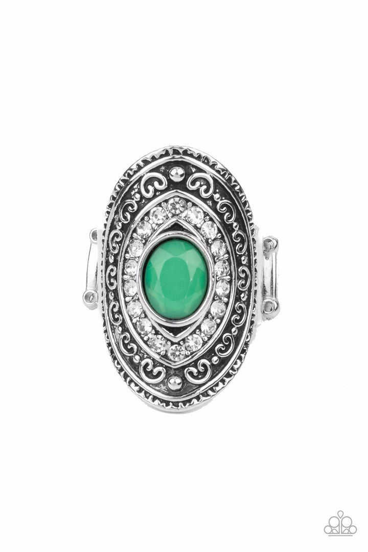 Entrancing Enchantment - Green and Silver Ring - Paparazzi Accessories - Bordered in glassy white rhinestones, a dewy Leprechaun rhinestone is pressed into the center of an oval silver frame embossed in frilly filigree, creating an ethereal centerpiece atop the finger. Features a stretchy band for a flexible fit. Sold as one individual ring.