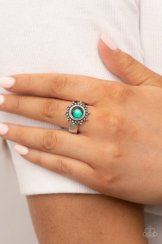 Expect Sunshine and REIGN - Green and Silver Ring - Paparazzi Accessories - Dainty silver studs radiate out from an oversized green rhinestone center, resulting into a radiant sunburst frame atop the finger. Features a dainty stretchy band for a flexible fit. Sold as one individual ring.