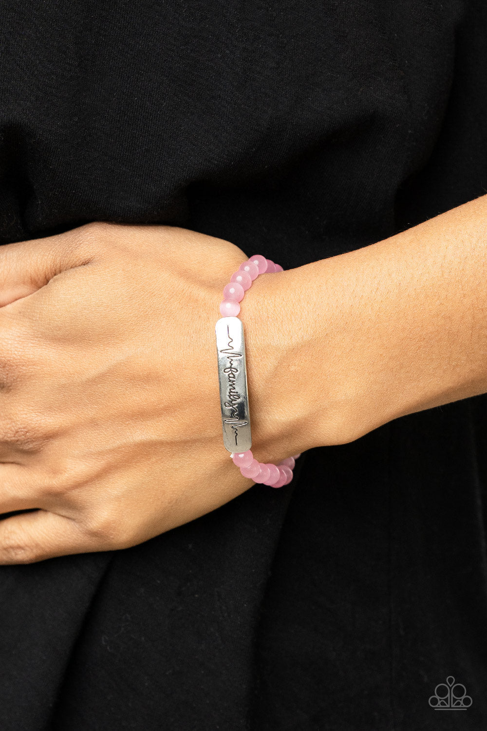 Family is Forever - Pink Cat's Eye Stone and Silver - Stretchy Bracelet - Paparazzi Accessories - Stamped in heartbeats and the word, "Family," a shiny silver plate attaches to a strand of pink cat's eye stone beads that are threaded along a stretchy band, creating a whimsically sentimental centerpiece around the wrist - Bejeweled Accessories By Kristie - Trendy fashion jewelry for everyone -