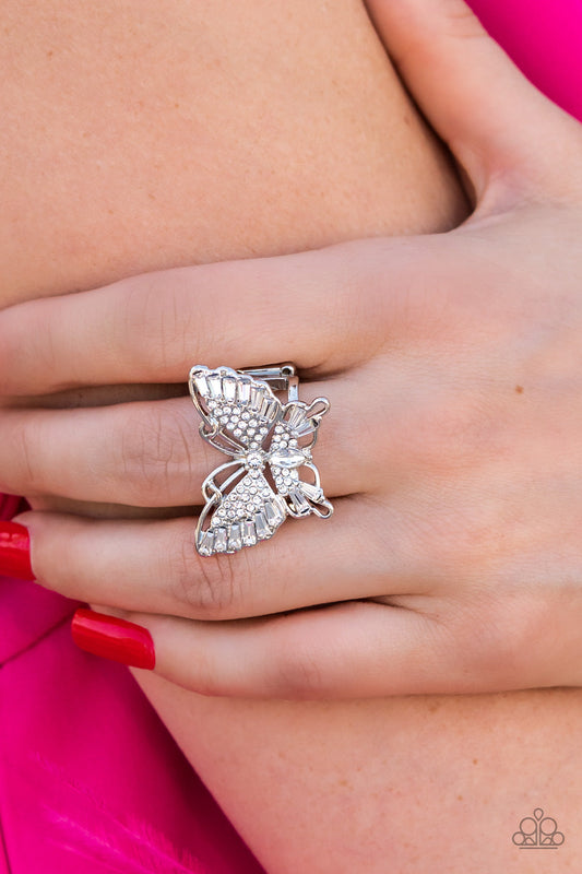 Fearless Flutter - White and Silver Butterfly Ring - Paparazzi Accessories - Sparkling with round, teardrop, and emerald cut white rhinestones, a silver butterfly fearlessly flutters atop the finger for a statement-making finish. Features a stretchy band for a flexible fit. 