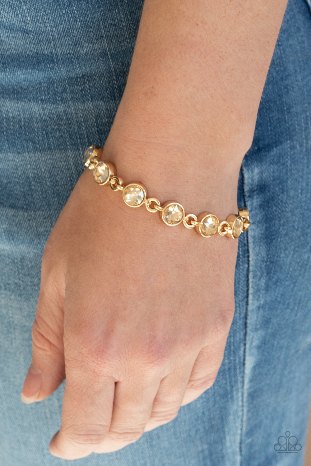 First In Fashion Show - Gold Fashion Bracelet - Paparazzi Accessories - Golden rhinestone encrusted gold frames delicately link around the wrist, creating a timeless centerpiece. Features an adjustable clasp closure. Sold as one individual bracelet.