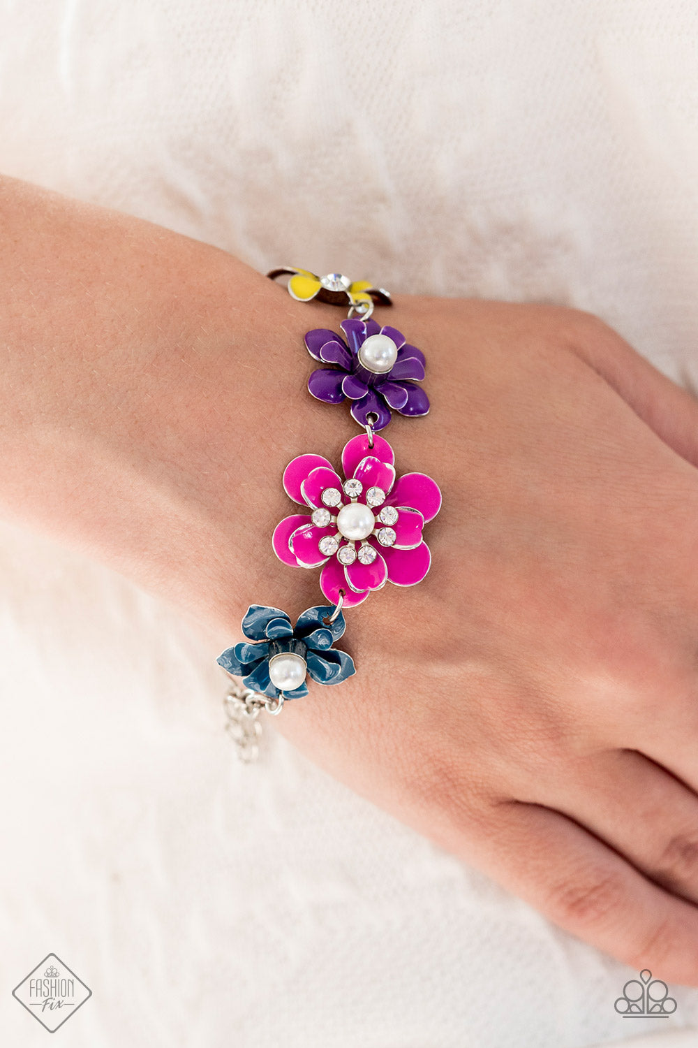 Flower Patch Fantasy - Multi Color Flower Bracelet - Paparazzi Accessories - A collection of colorful flowers link around the wrist to create a vibrant statement piece. A mix of shimmery pearls and sparkling white rhinestones decorate the center of each flower, infusing the piece with handcrafted whimsicality. Features an adjustable clasp closure fashion bracelet.