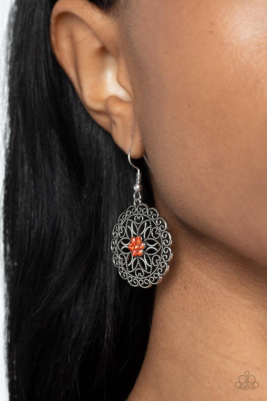 Flower Shop Sparkle - Sparkly Orange and Silver Fashion Earrings - Paparazzi Accessories - Bejeweled Accessories By Kristie - Silver petals fan out from a sparkly orange rhinestone center inside a frilly ring of silver filigree, resulting in a whimsical floral frame fashion earrings.