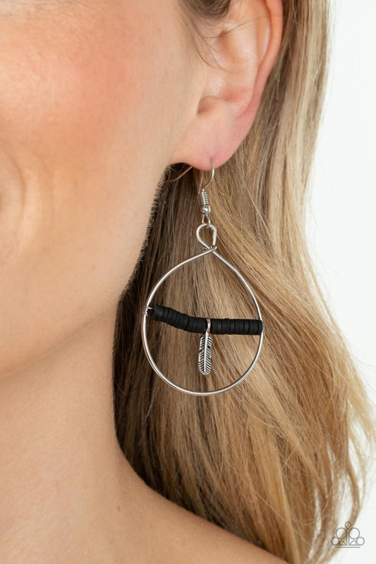 Free Bird - Black and Silver Fashion Earrings - Paparazzi Accessories - Infused with a dainty silver feather charm, a dainty row of rubbery black discs are threaded along a metallic rod inside an airy silver hoop for a free-spirited fashion. Earring attaches to a standard fishhook fitting. Sold as one pair of earrings.
