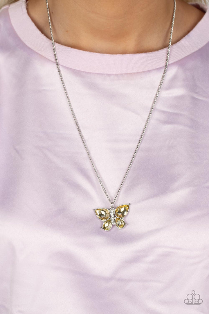 Free-Flying Flutter - Yellow Butterfly and Silver Necklace - Paparazzi Accessories - A silver butterfly with yellow teardrop rhinestone wings and a white-rhinestone body delicately flutters at the bottom of a silver chain. Features an adjustable clasp closure.