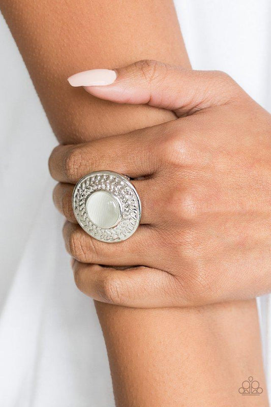 Garden Garland - White Moonstone Ring - Paparazzi Accessories - 
A glowing white moonstone is pressed into a large silver frame embossed in a leafy pattern for a whimsical look. Features a stretchy band for a flexible fit.
