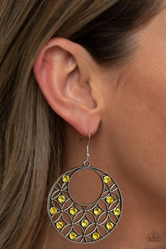 Garden Garnish - Yellow and Silver Earrings - Paparazzi Accessories - Dotted with glittery Illuminating rhinestones, an airy backdrop of antiqued flowers climb a studded silver hoop for a whimsical look. Earring attaches to a standard fishhook fitting. Sold as one pair of earrings.
